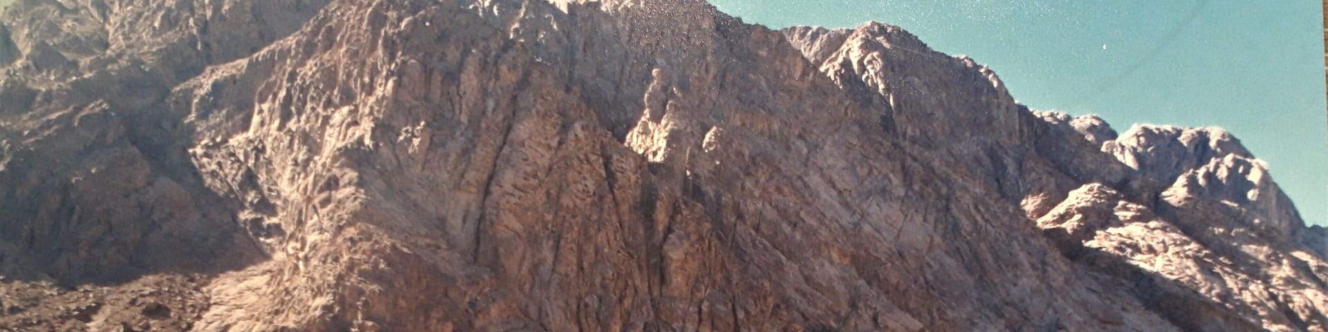 Digitized paper photo (taken in the 1990's). African adventures, areas where it is now unsafe to travel.
The Greek Orthodox monastery at the foot of Mount Sinai (called Jabal Musa or Moses Mountain by the Arabs) is located at the very place where God appeared to Moses in the Burning Bush, beneath the Mount of the Decalogue (Exodus 31:18). This is the oldest continuously inhabited Christian monastery, with a history that can be traced back over seventeen centuries.
The monastery has never been destroyed in all its history, and thus it can be said to have preserved intact the distinctive qualities of its Greek and Roman heritage. #Perspectives #Culture #LocalSecrets #History