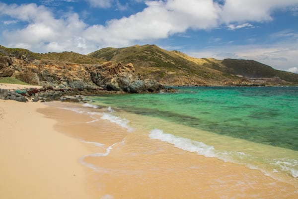 Pinel Island featuring general coastal views, a sandy beach and rugged coastline