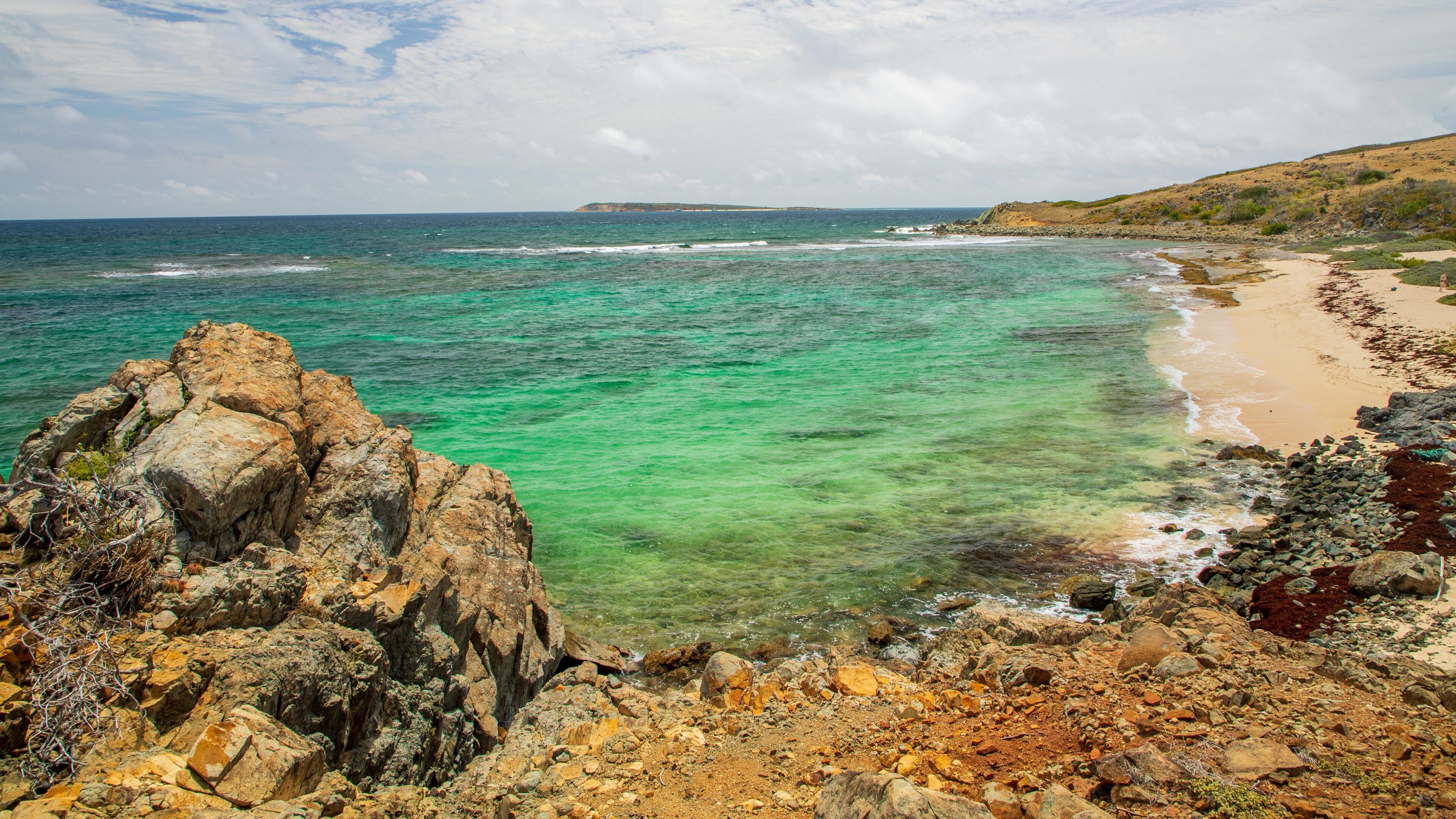 Pinel Island featuring general coastal views and rugged coastline