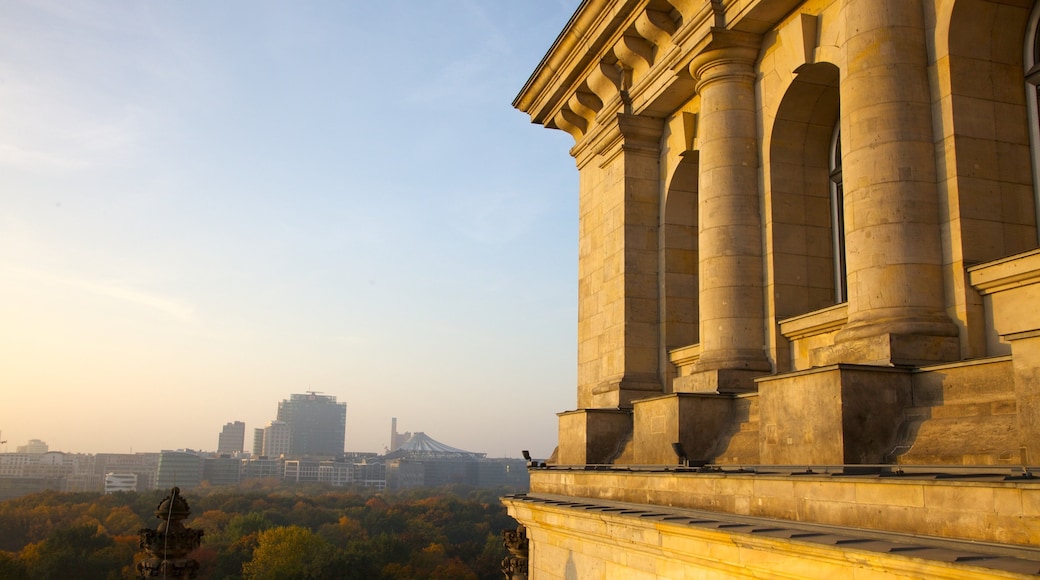 Reichstag Building which includes skyline, a sunset and mist or fog