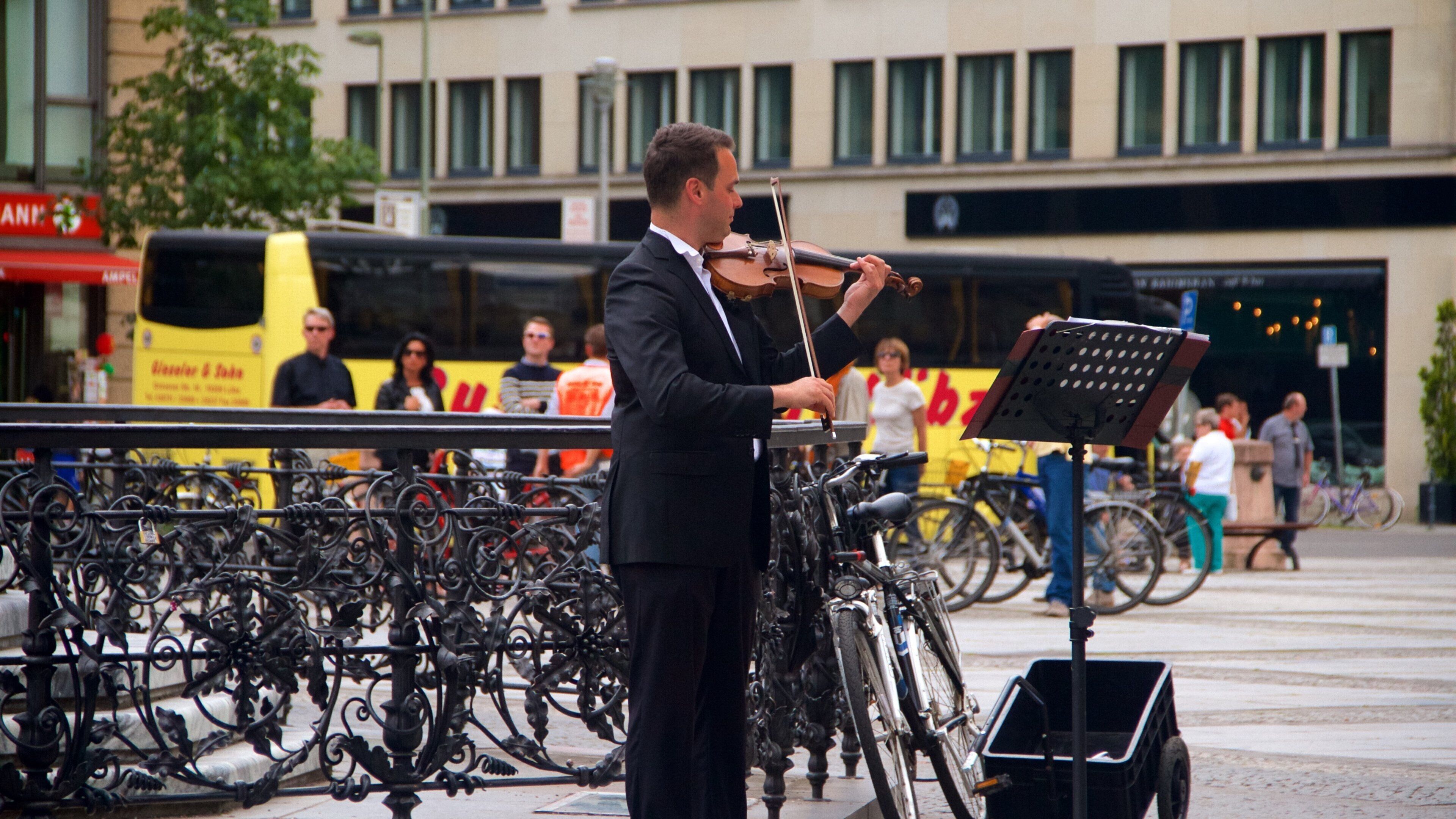 Gendarmenmarkt featuring music and street performance as well as an individual male