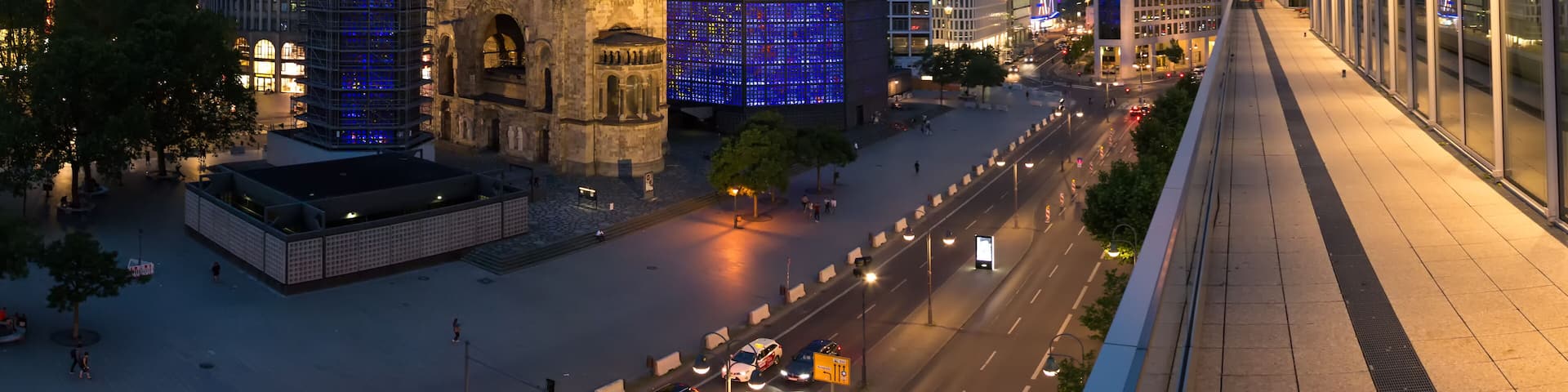 A cityscape at dusk with historic architecture and modern skyscrapers.