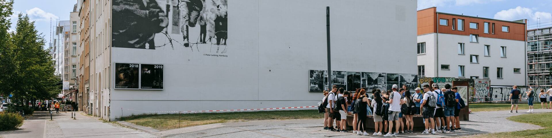A building with a large black and white mural and the text "1961" and "Bernauer Straße".