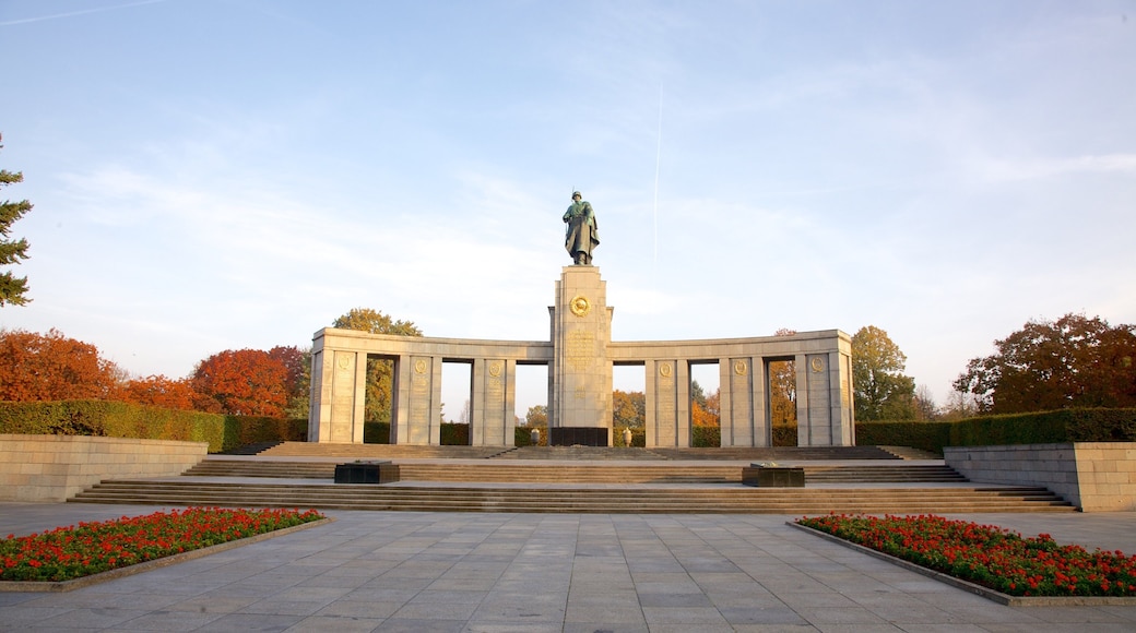 Tiergarten Soviet War Memorial showing a sunset, flowers and a statue or sculpture