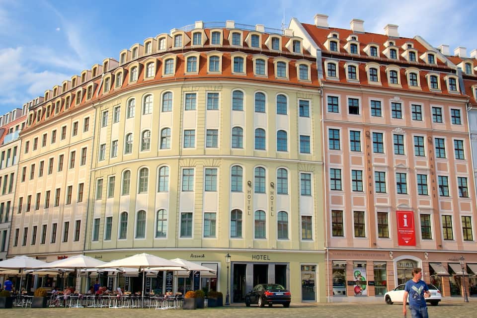 A historic building with multiple stories, featuring classic European architecture with arched windows and a curved facade.