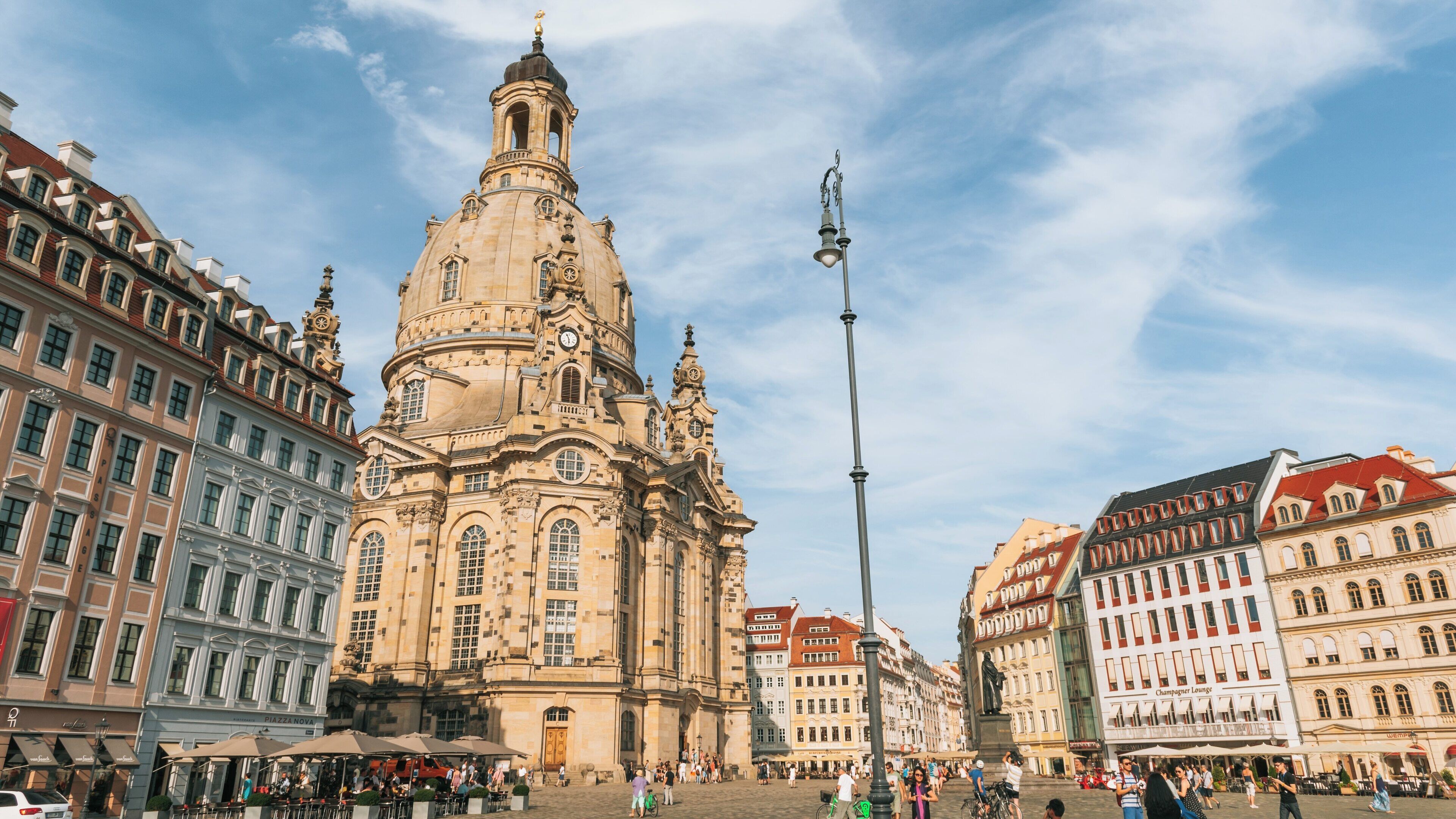 Enjoying the vibrant ambiance at New Market Square in Altstadt Dresden, Saxony, Germany on a sunny day filled with historic architecture and lively activity