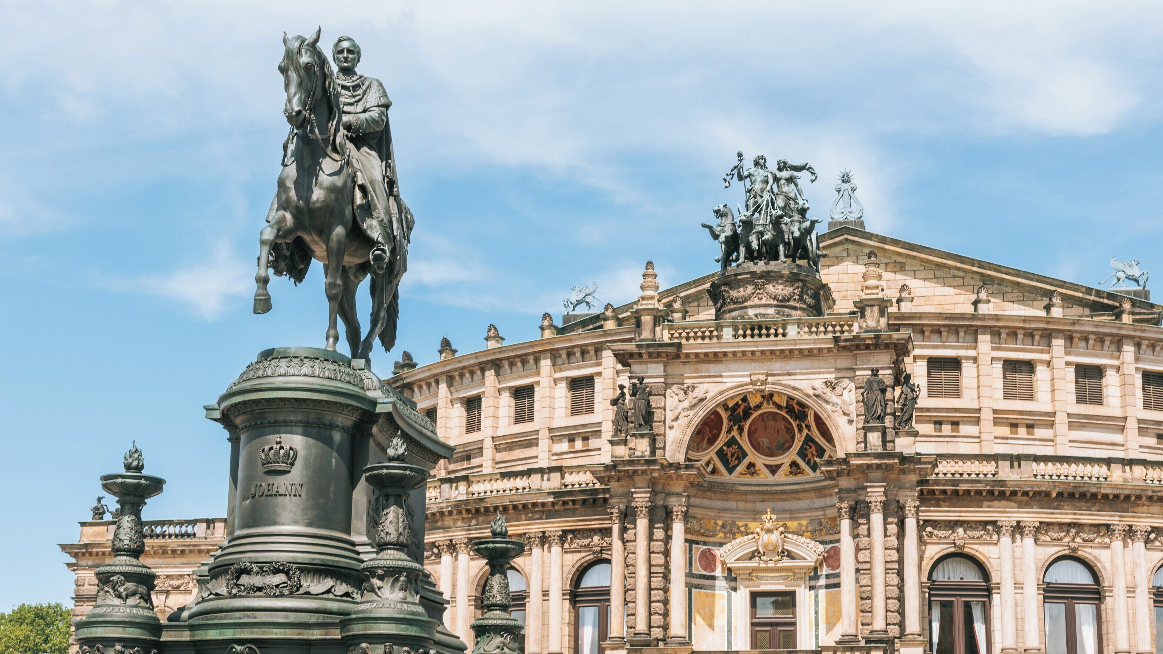 View of Semper Opera House with statue of King Johann in Altstadt Dresden, Saxony, Germany during a clear day