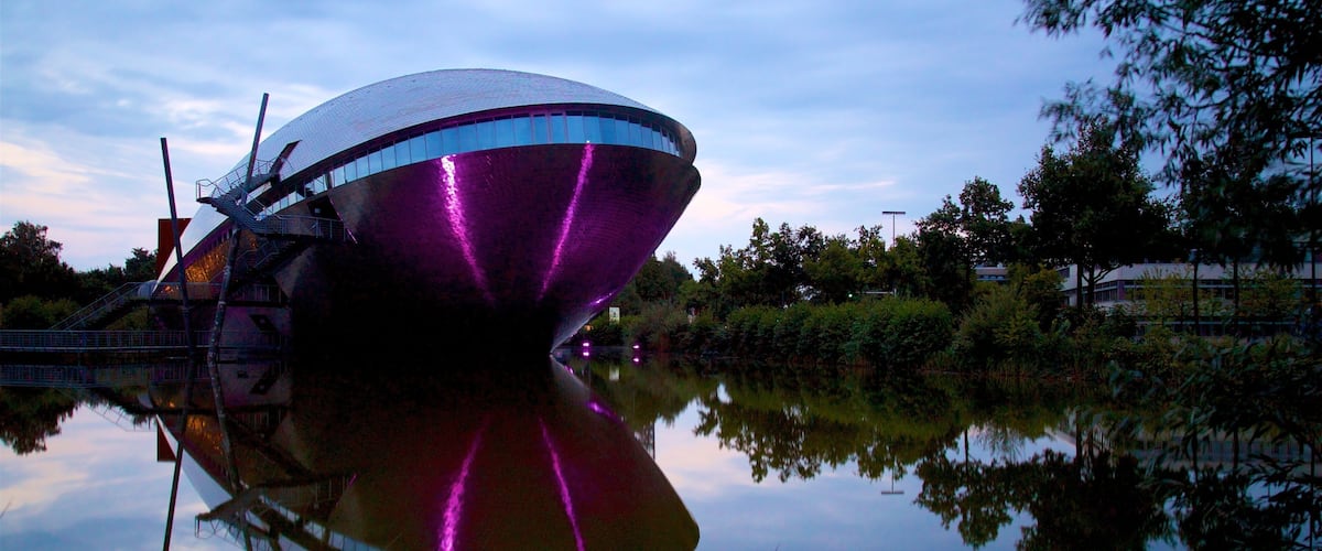 Universum Science Center featuring modern architecture and a lake or waterhole