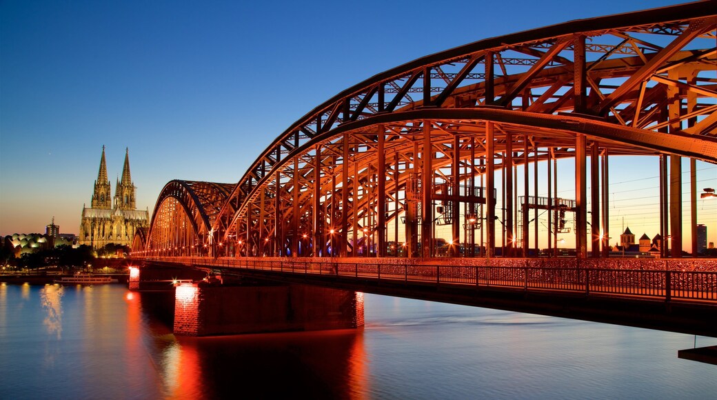 Hohenzollern Bridge showing a bridge, a sunset and a river or creek