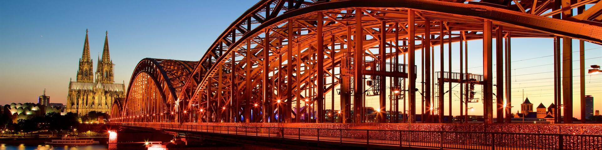 Hohenzollern Bridge showing a bridge, a sunset and a river or creek