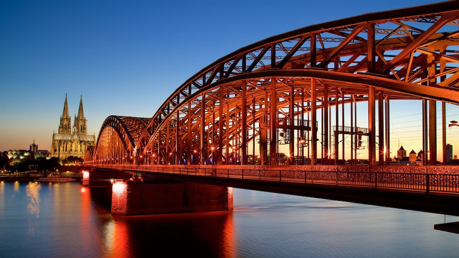 Hohenzollern Bridge showing a bridge, a sunset and a river or creek