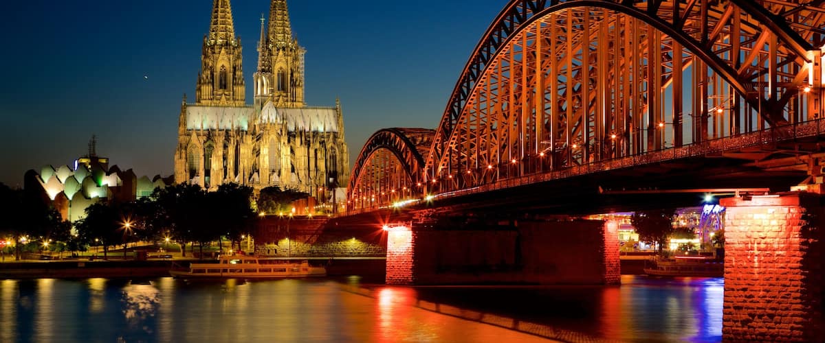 A bridge with a gothic cathedral in the background.