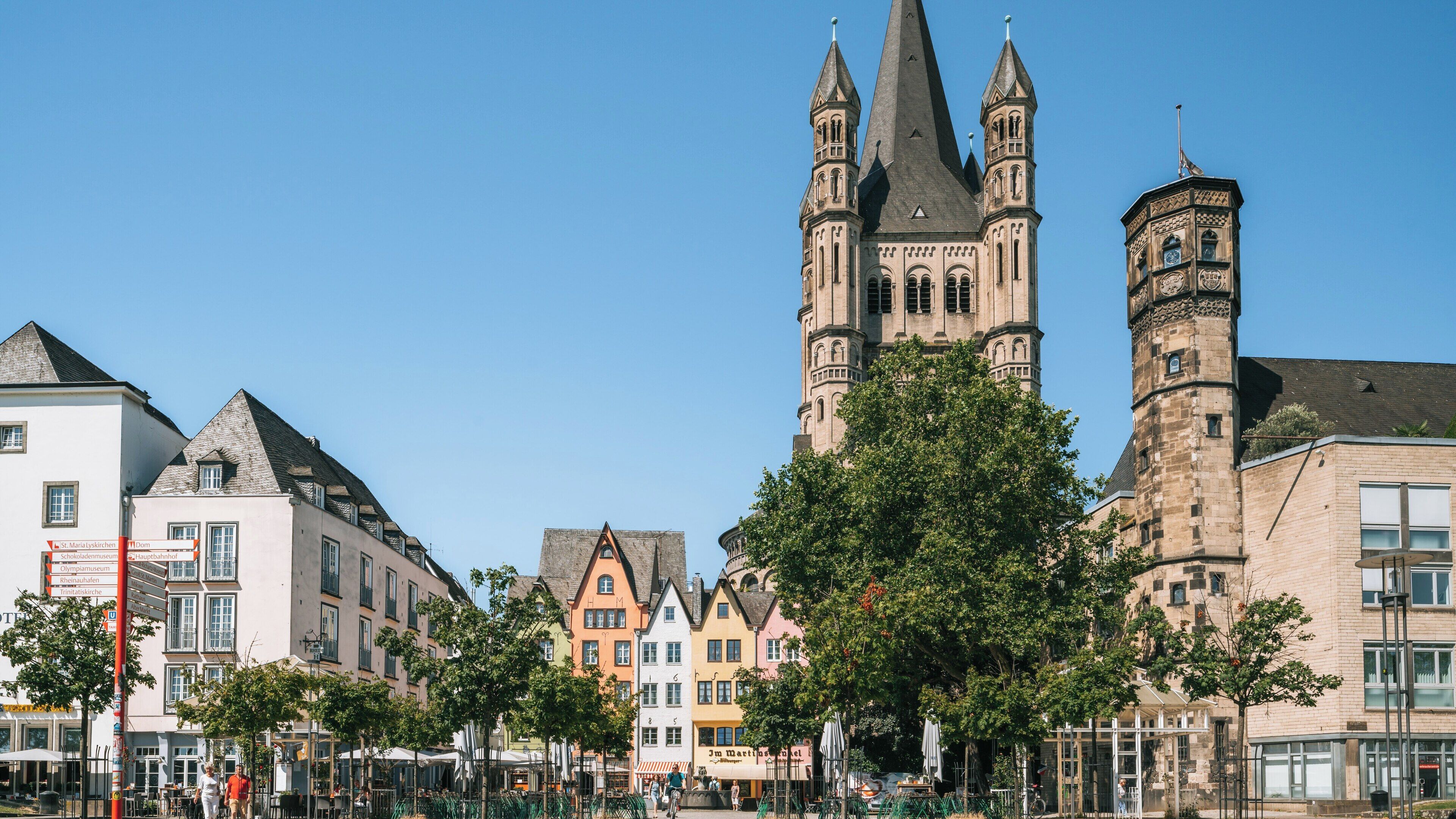Exploring Great St. Martin Church in Altstadt-Nord, Cologne, with its distinctive architecture and surrounding vibrant city life