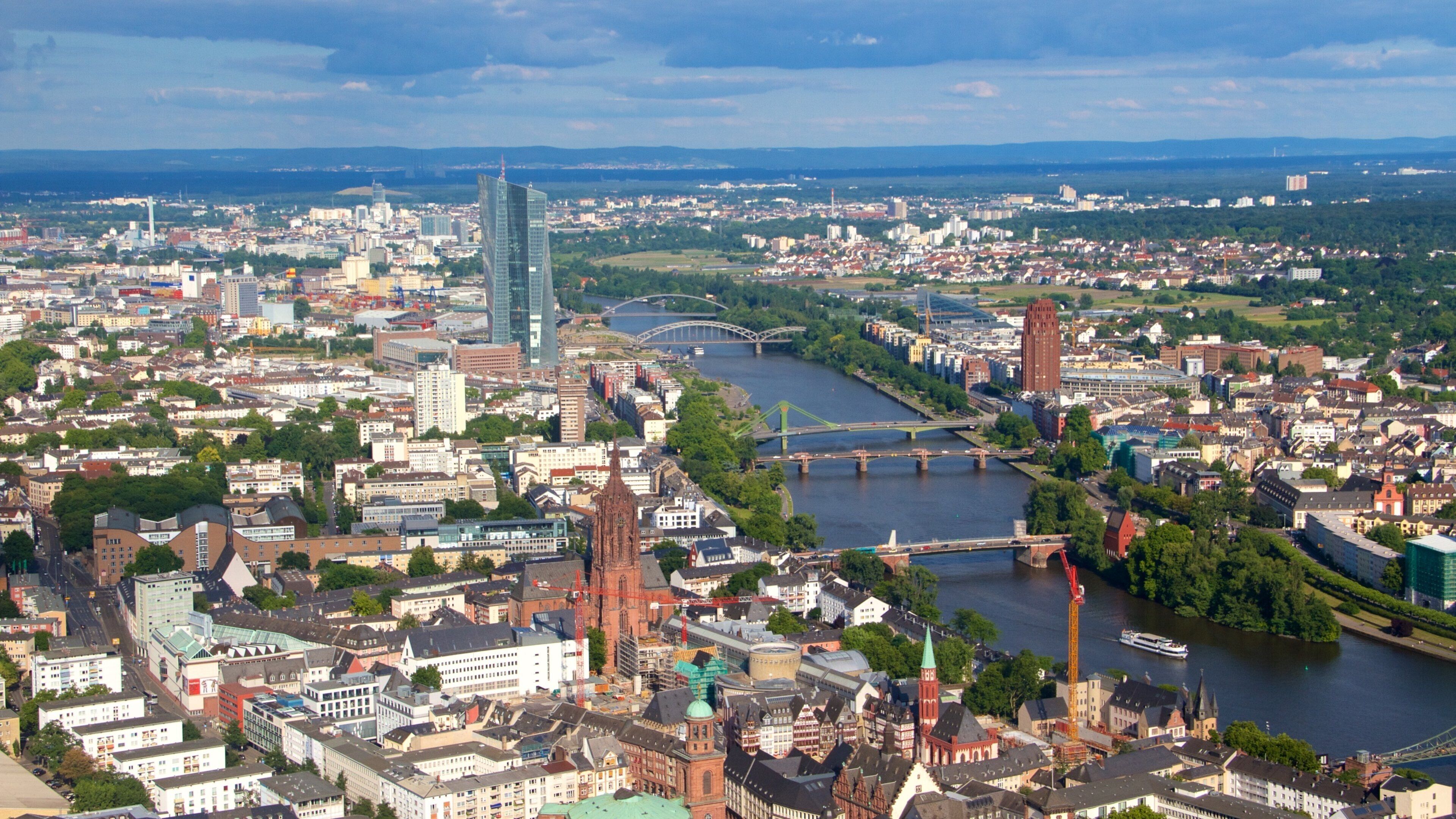 A panoramic view of a city with a river, bridges, and a mix of historic and modern architecture.