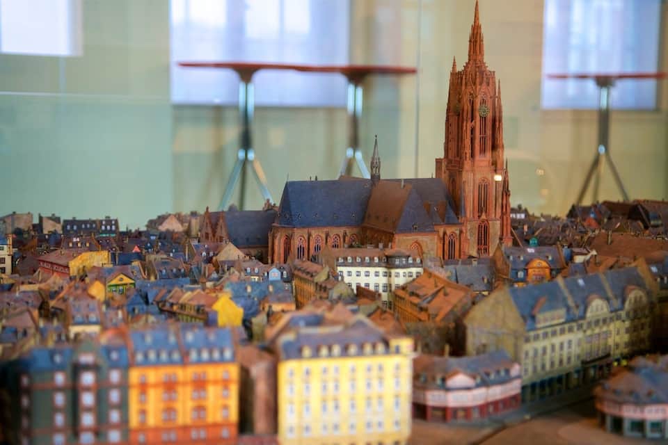 A detailed model of a historic European city with a prominent cathedral and various colorful buildings.