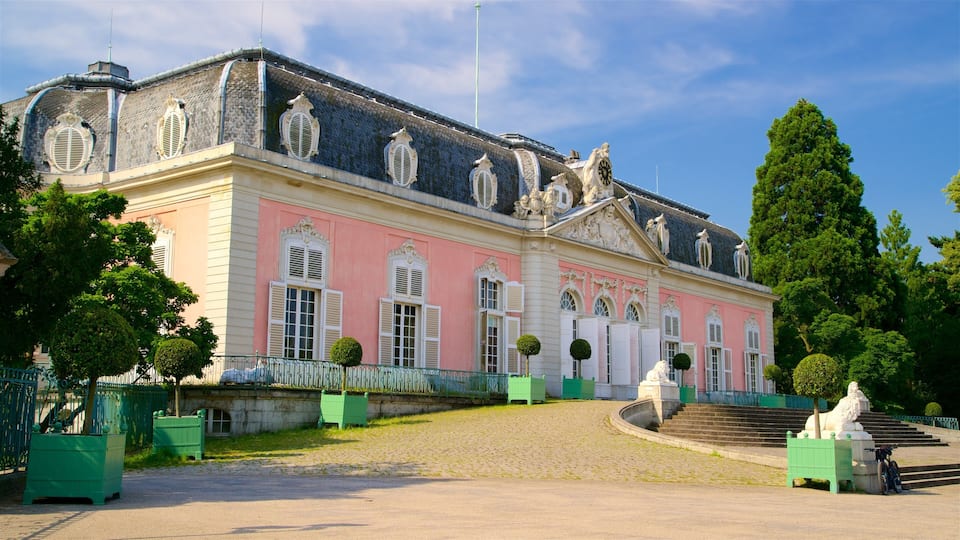 A pink and grey historic building with ornate windows and statues.