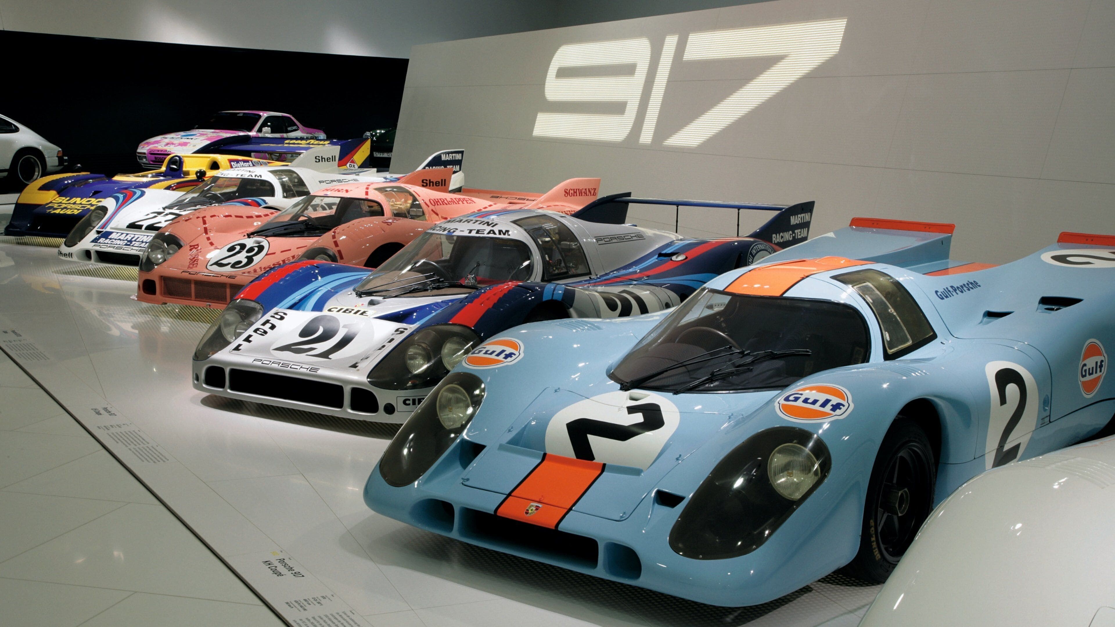 A collection of vintage racing cars in a museum.