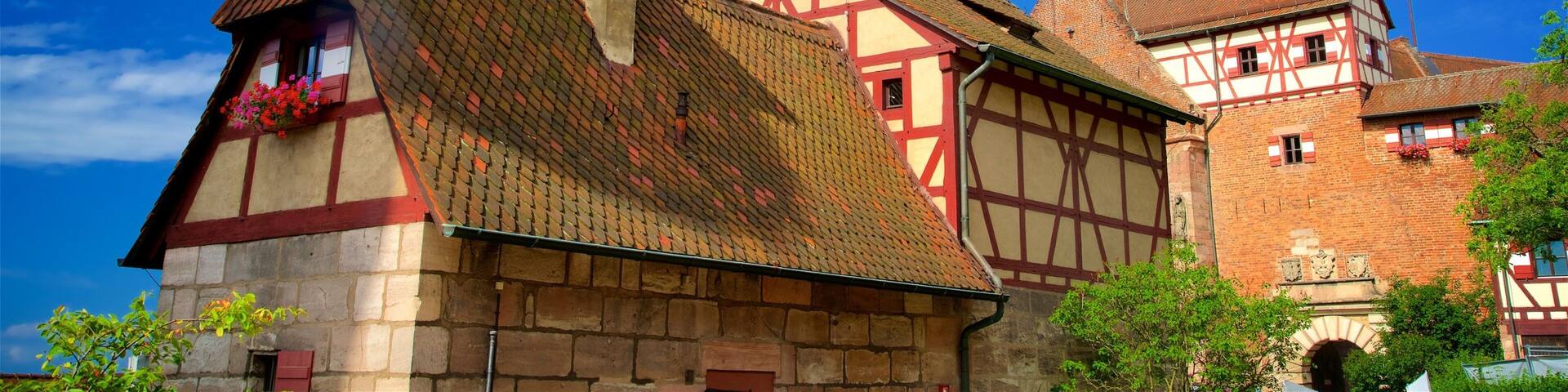 A traditional half-timbered house with a tower and a flag.