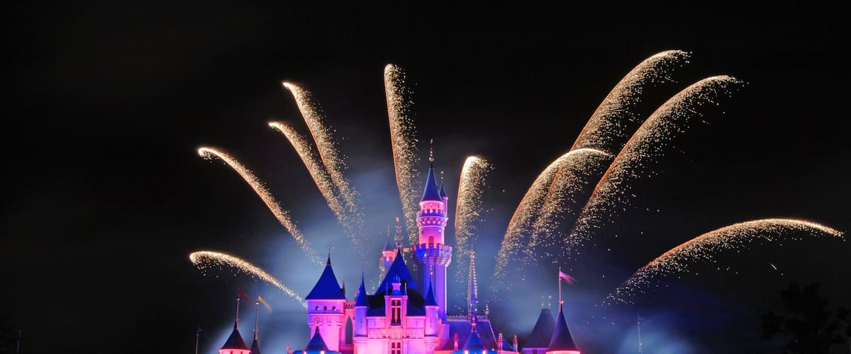 Hong Kong Disneyland featuring rides, château or palace and night scenes