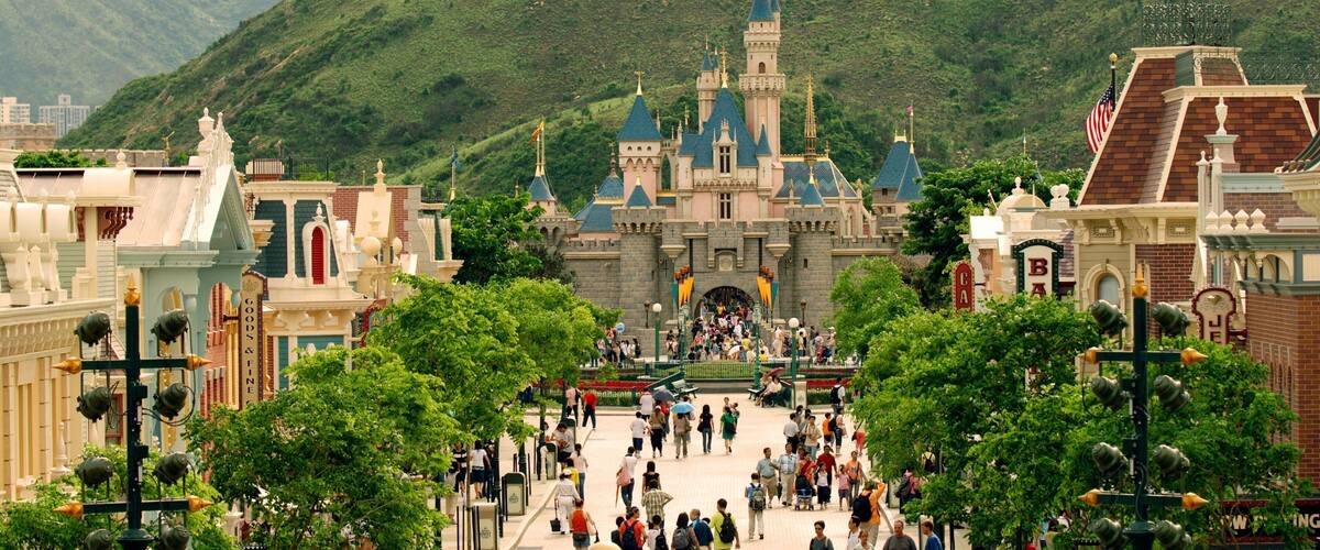 Hong Kong Disneyland® Resort featuring rides as well as a large group of people