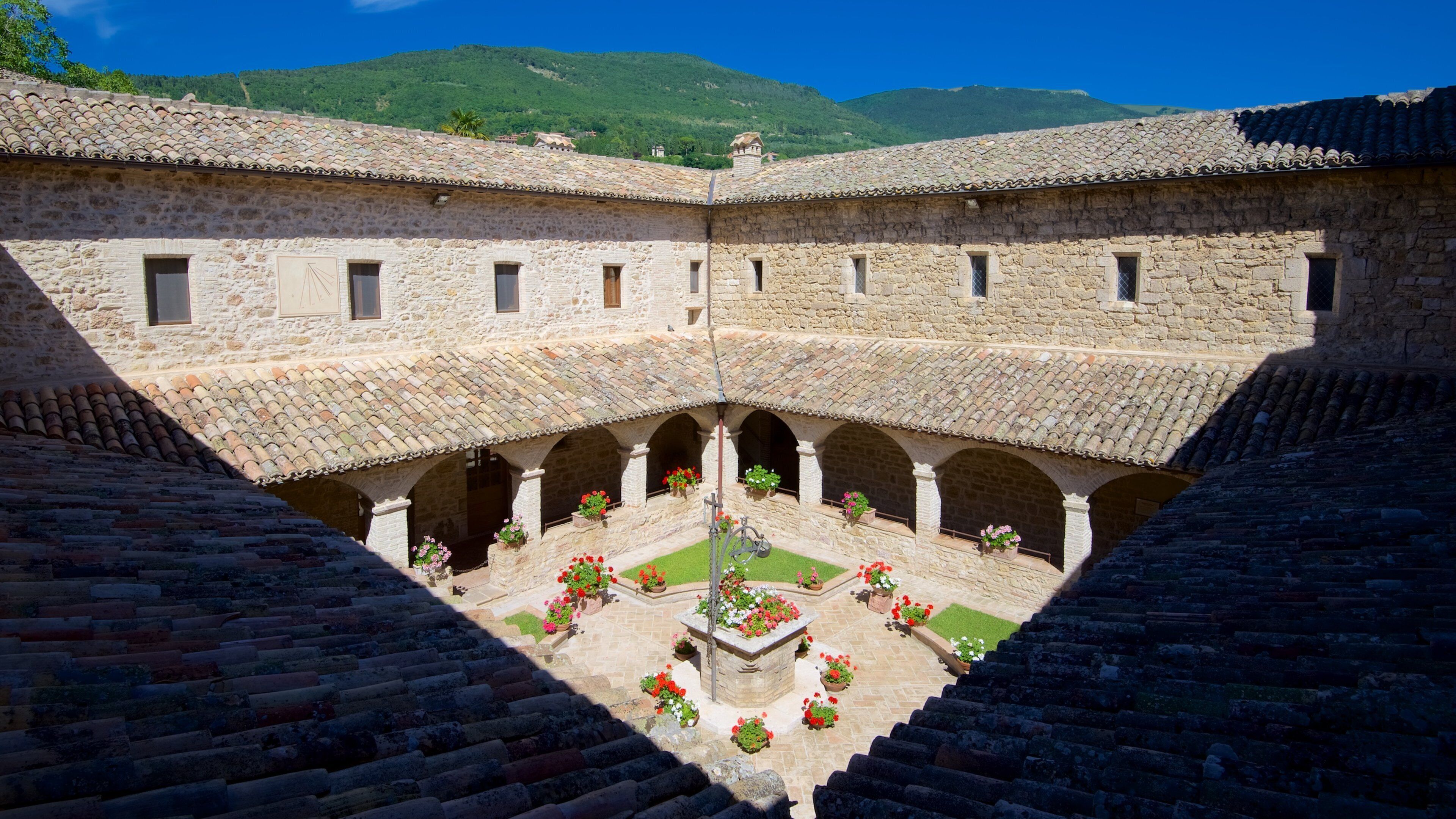 San Damiano showing heritage architecture and flowers