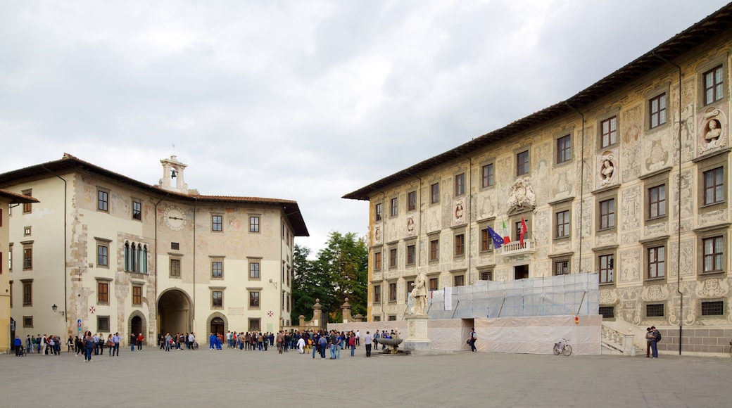 Palazzo della Carovana which includes a square or plaza, heritage architecture and a city
