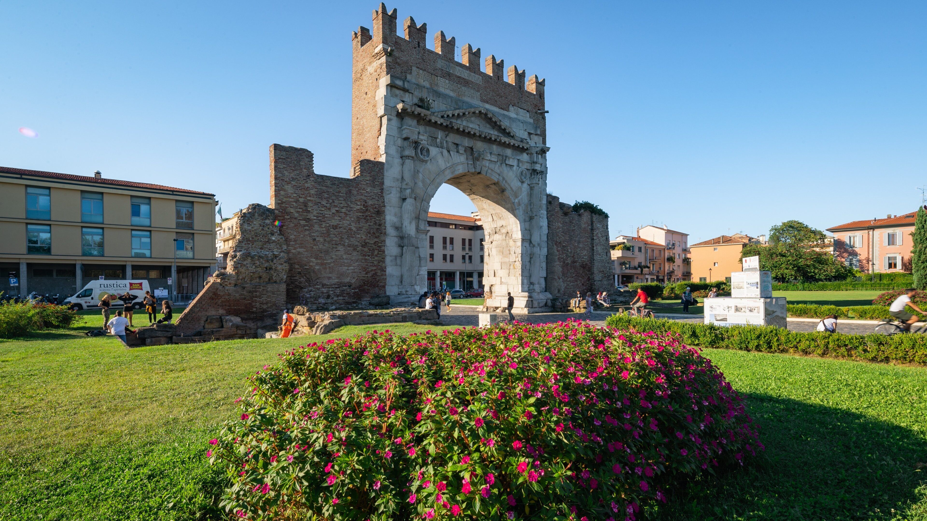 Arch of Augustus showing heritage elements and wildflowers