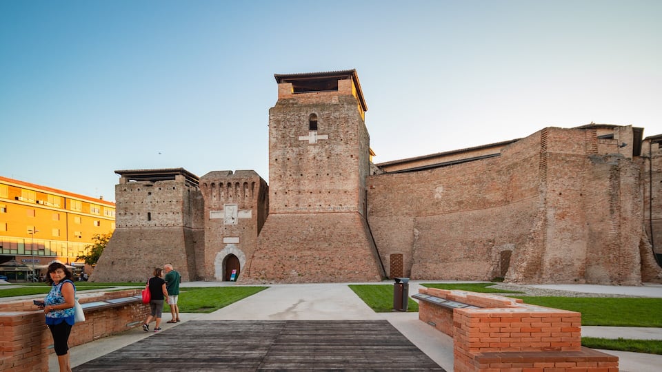 A historic brick fortress with a central tower and battlements.