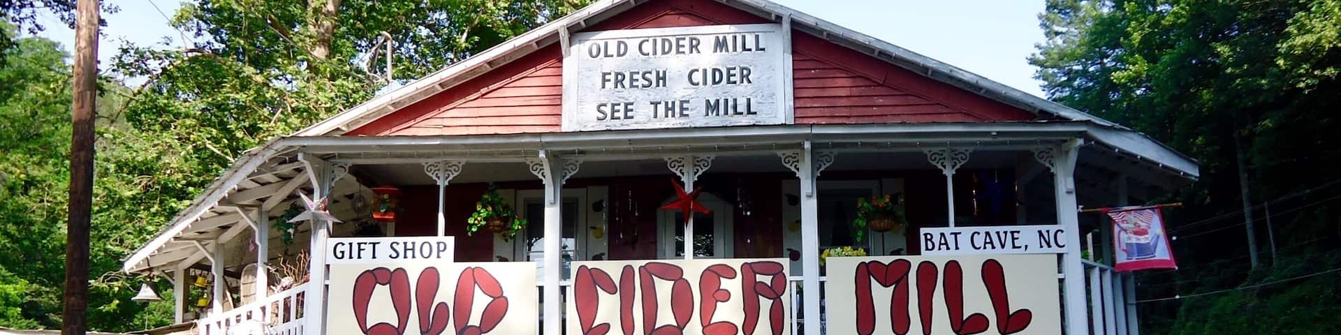 A building with signs for 'Old Cider Mill' and 'Gift Shop'.