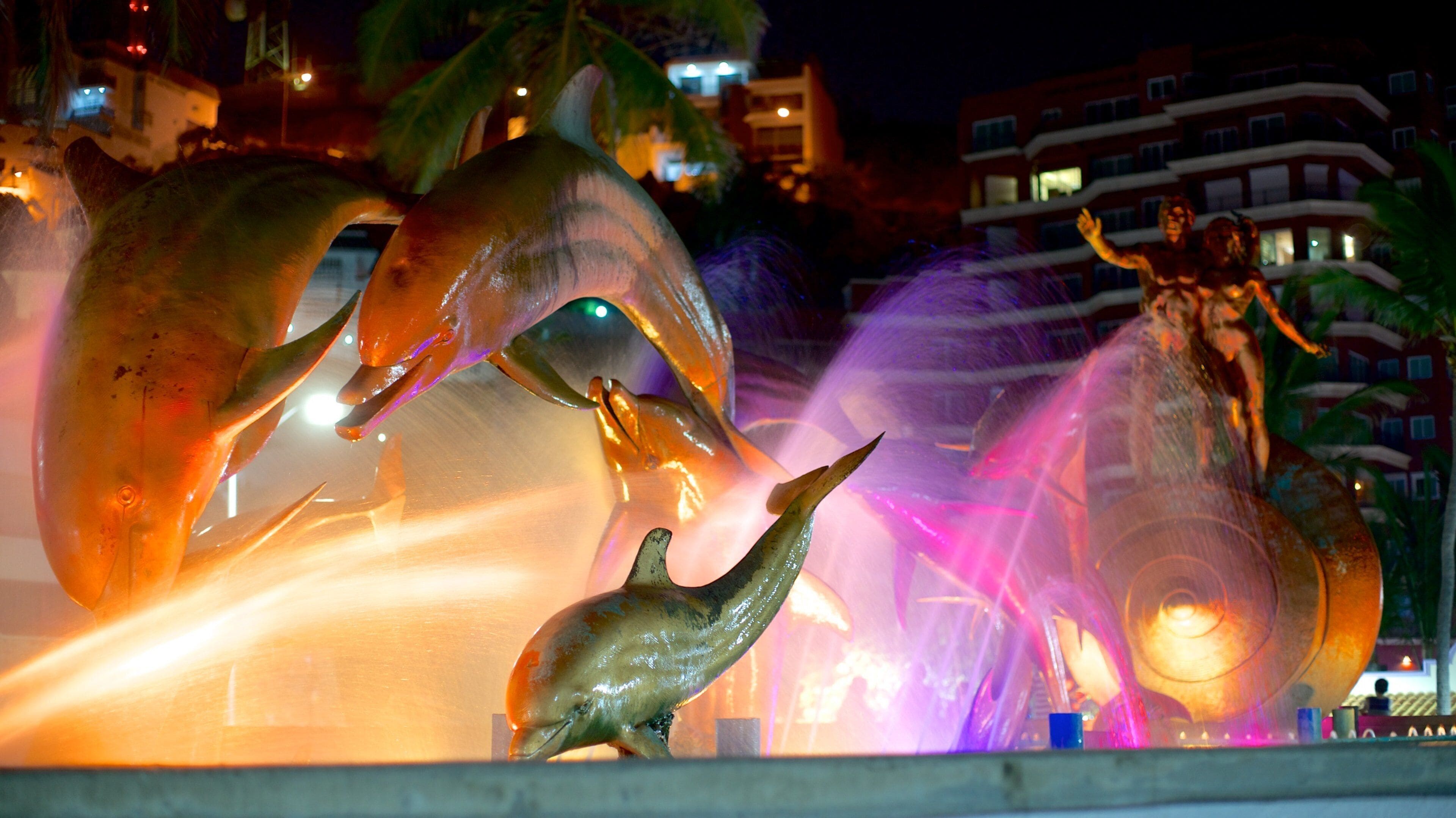 Olas Altas Beach showing a statue or sculpture, night scenes and a fountain