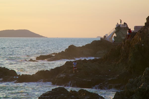 Divers Point which includes rugged coastline, views and a sunset
