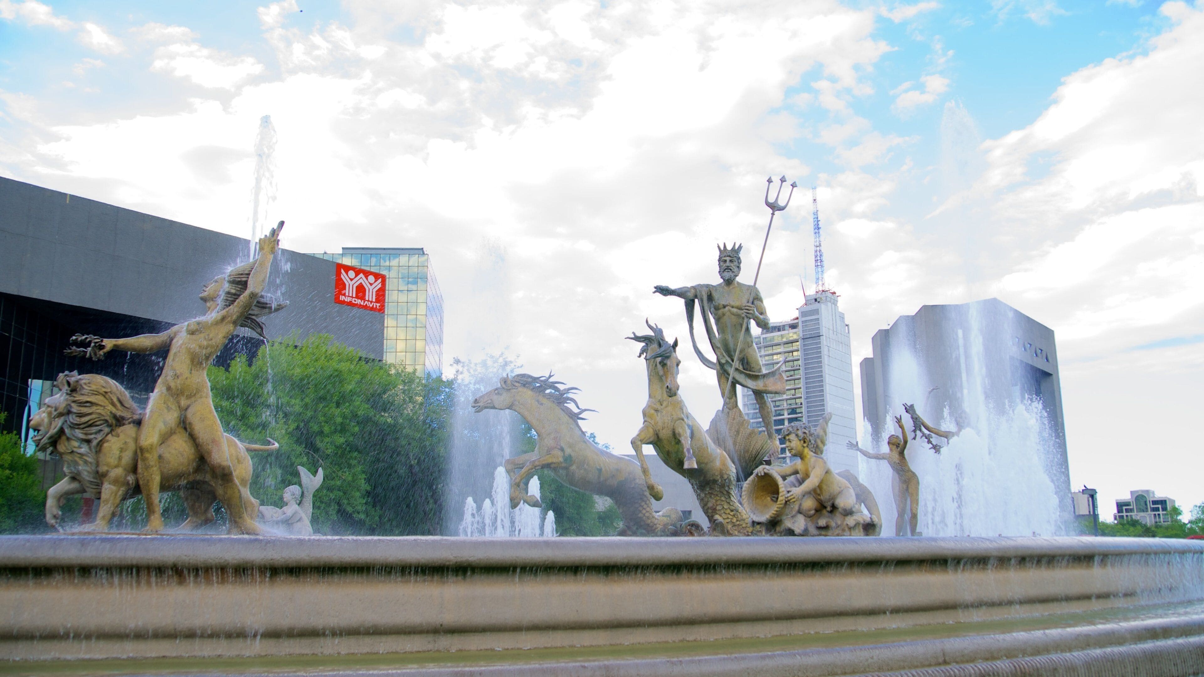 Fuente de la Vida o Neptuno which includes outdoor art, a city and a statue or sculpture