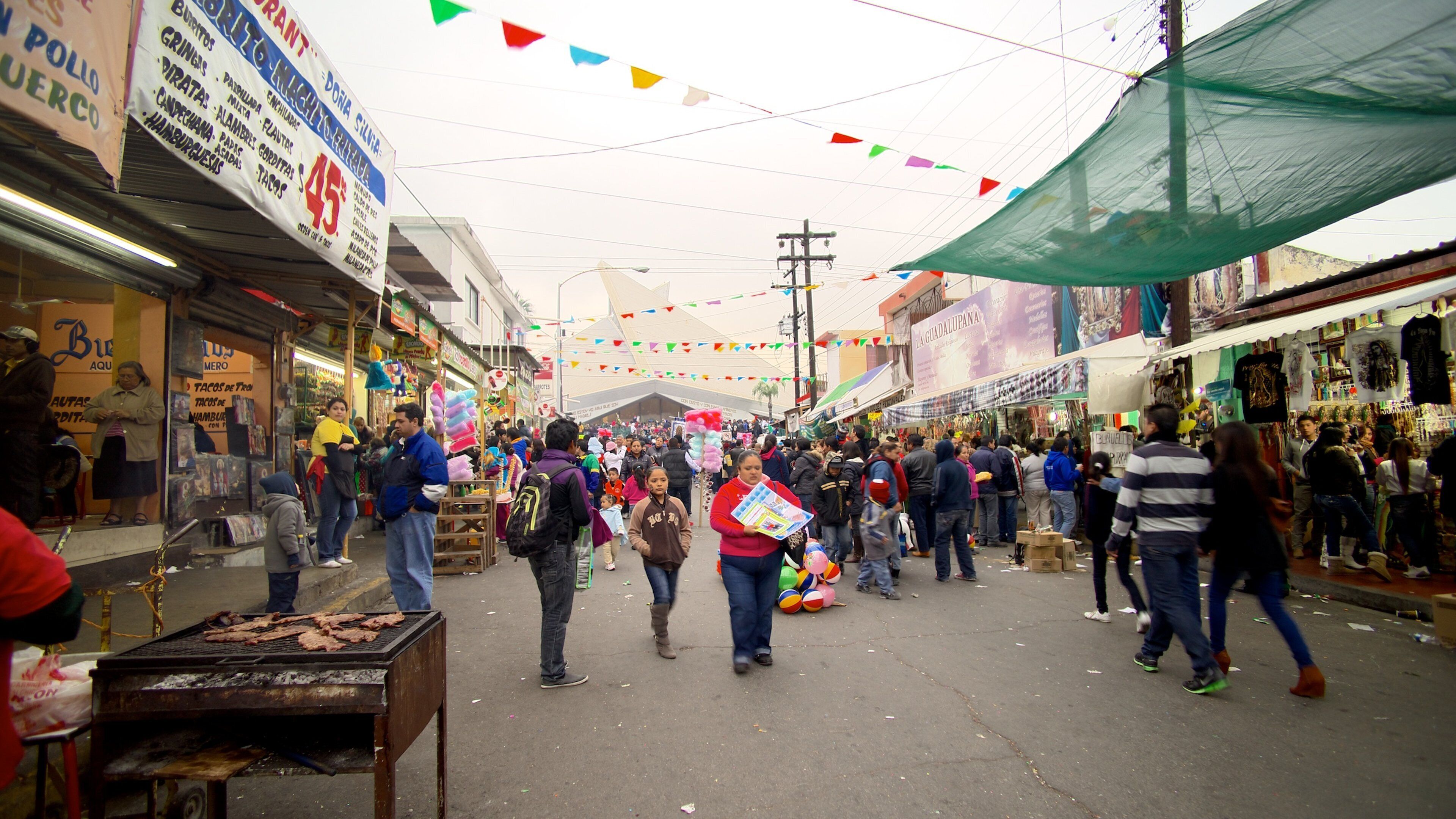 Basilica de Guadalupe showing street scenes and a city as well as a large group of people