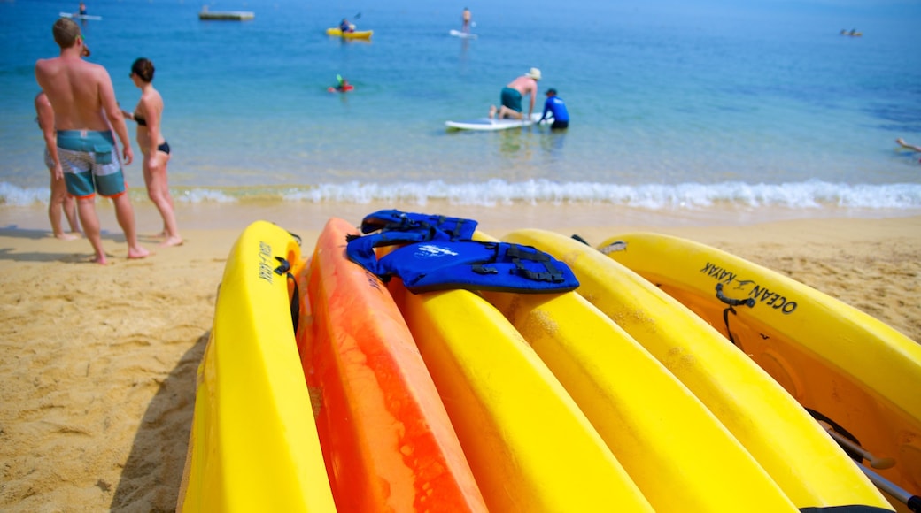 Las Caletas Beach featuring a sandy beach and kayaking or canoeing as well as a small group of people
