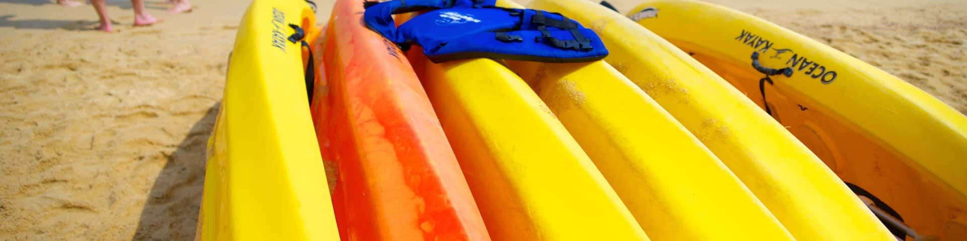 Las Caletas Beach featuring a sandy beach and kayaking or canoeing as well as a small group of people