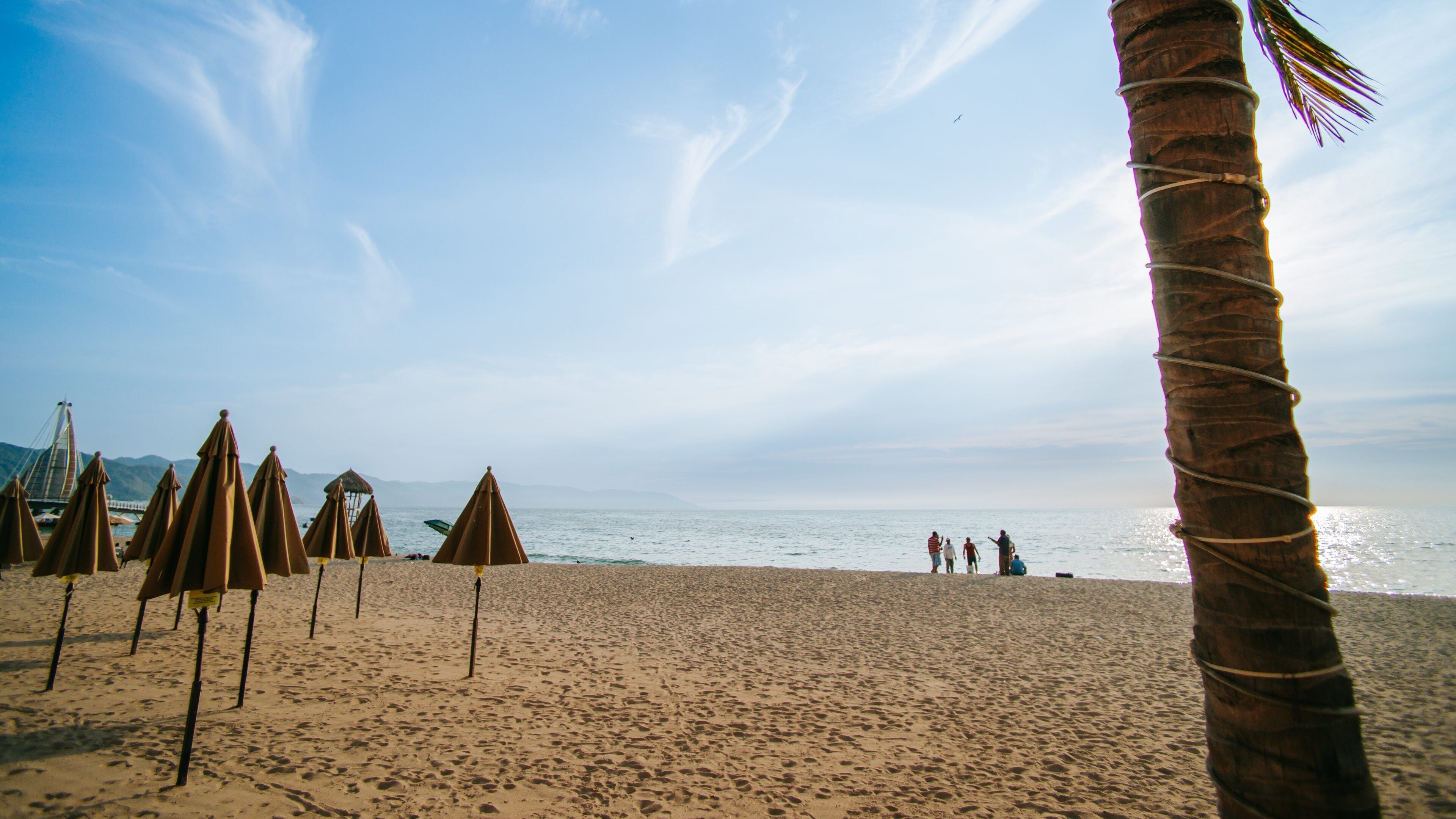 Bay of Banderas featuring a sunset, a sandy beach and general coastal views