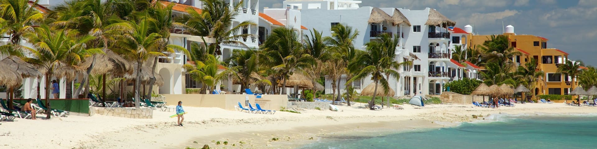 Half Moon Bay which includes a sandy beach, a coastal town and tropical scenes