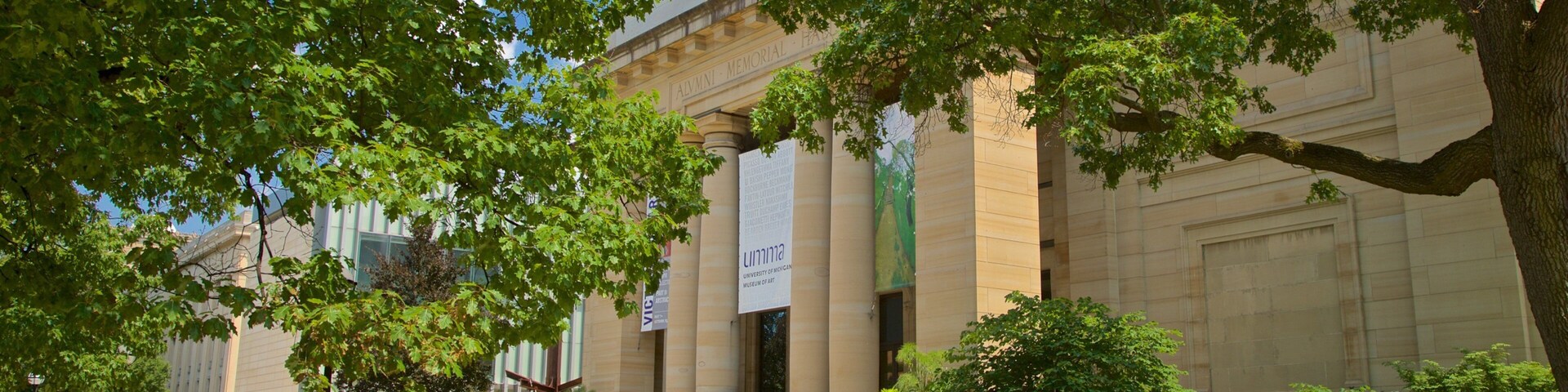 University of Michigan Museum of Art featuring a garden and heritage architecture as well as a small group of people