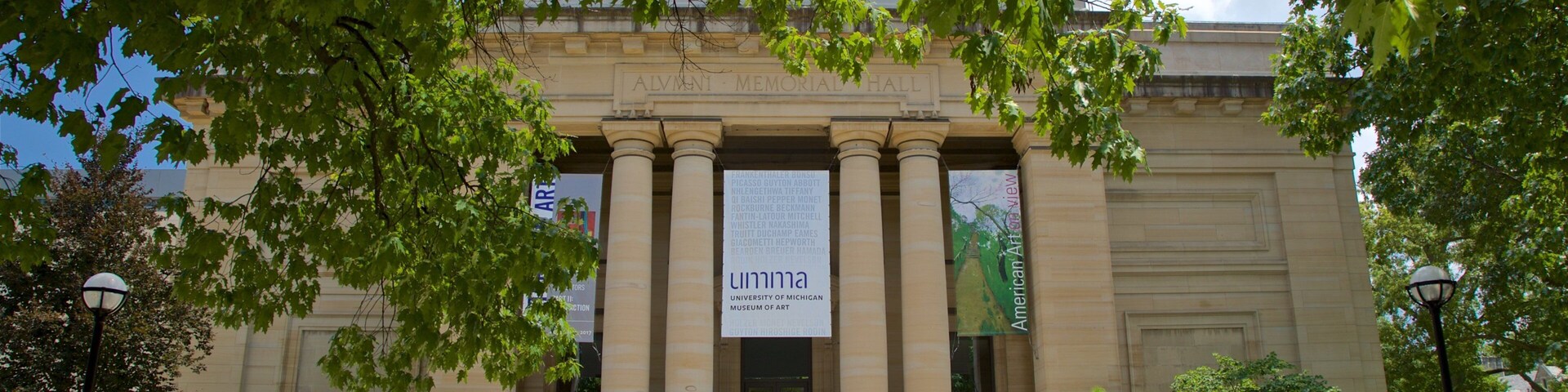 A university building with columns and banners.