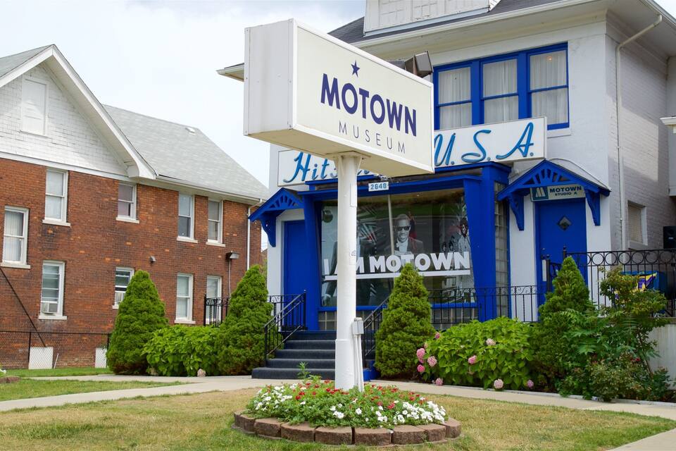 A building with a sign reading "Motown Museum USA" and a blue and white color scheme.