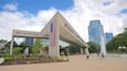 The Gerald R. Ford Presidential Center with an American flag, a statue, and a fountain.