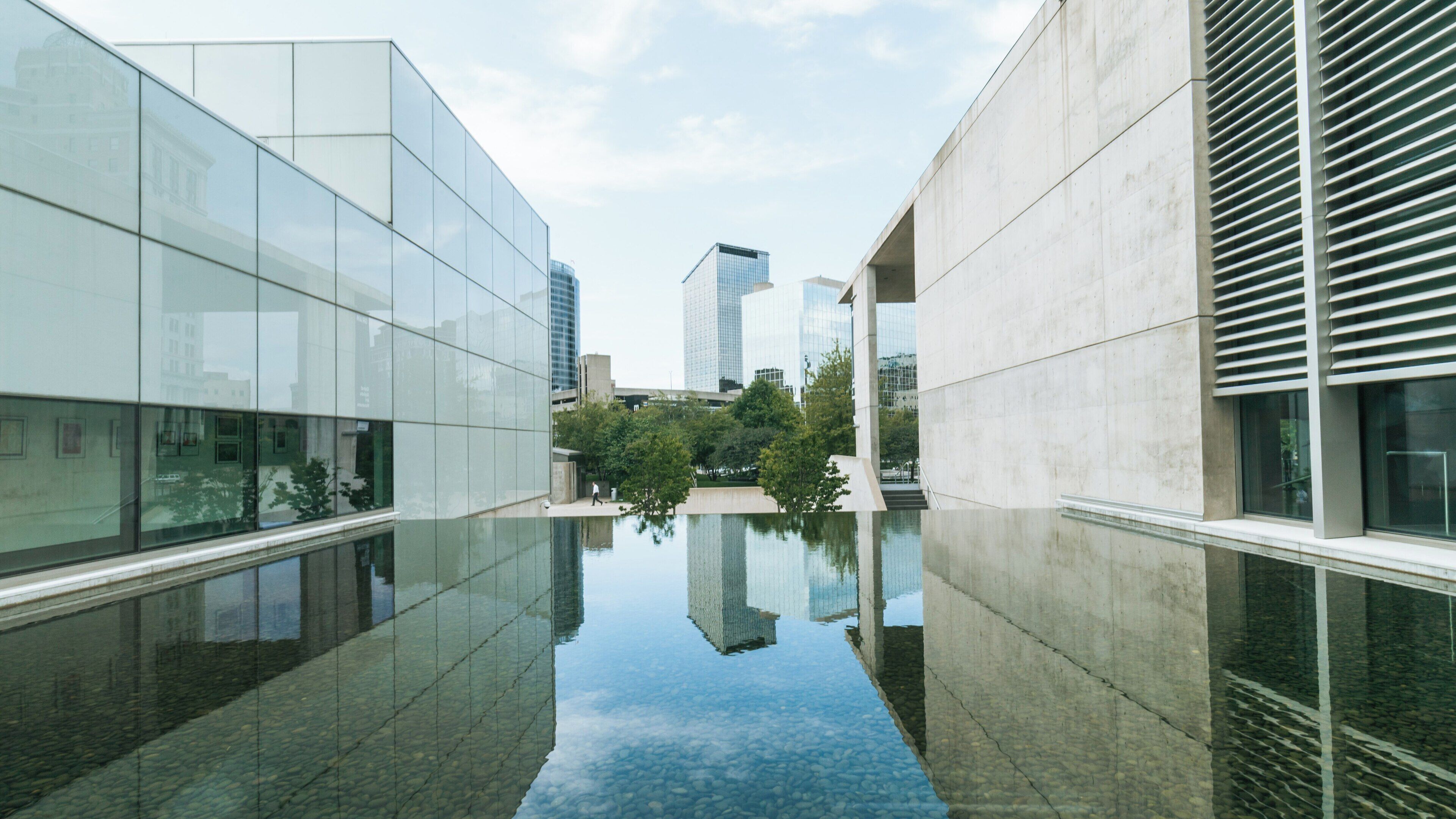 Exploration of modern architecture and serene reflections at Grand Rapids Art Museum in Heartside, Michigan during daylight