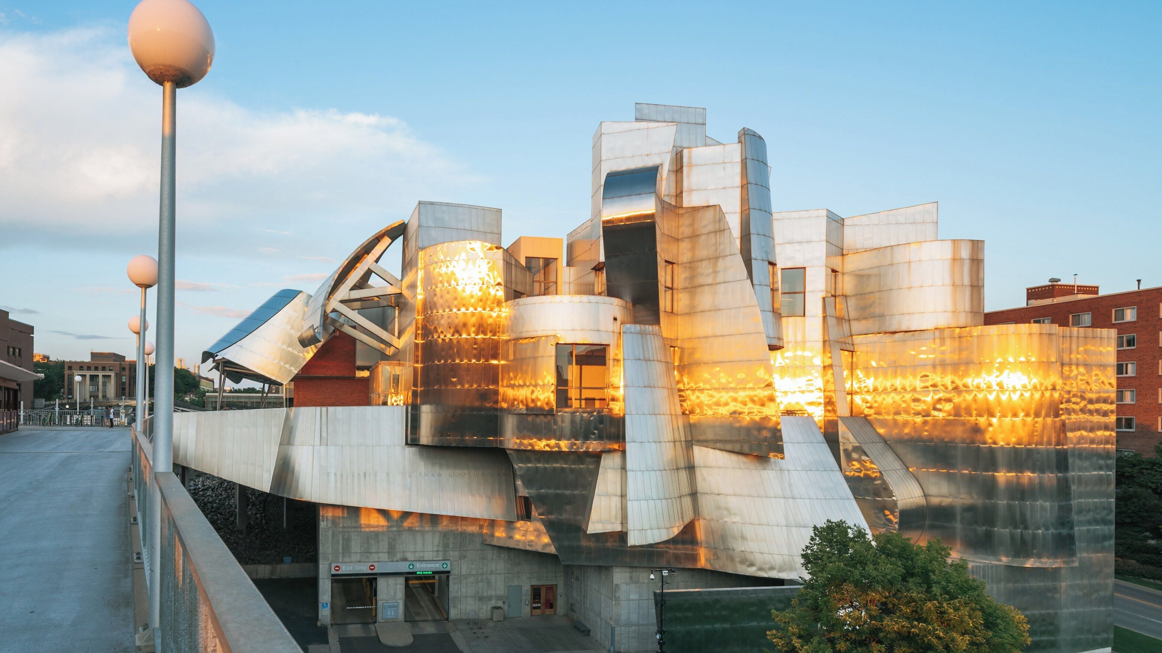 Weisman Art Museum glows under the evening sun in Dinkytown Minneapolis showcasing striking architecture and vibrant reflections
