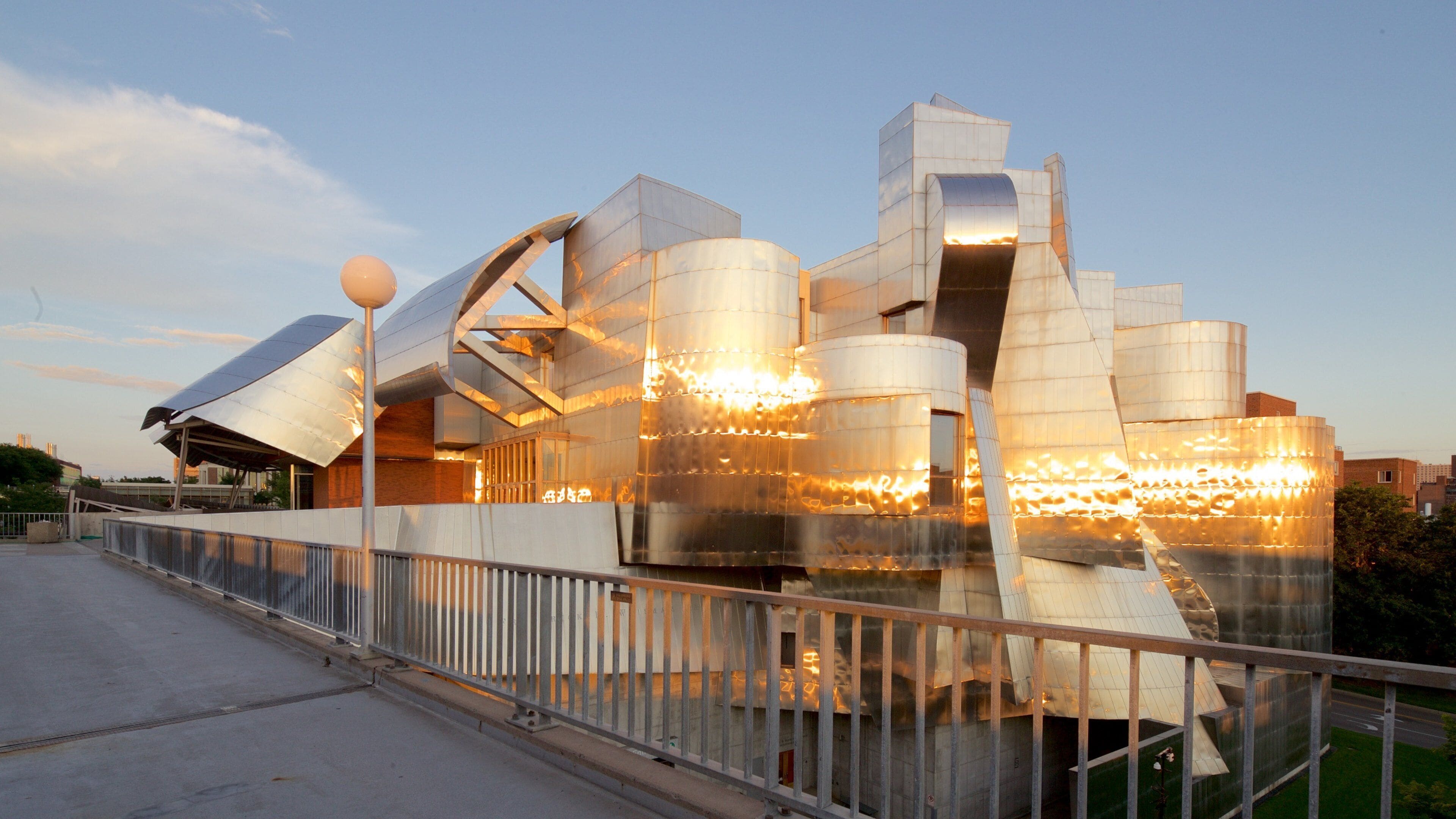 A modern architectural building with a metallic exterior and a unique design.