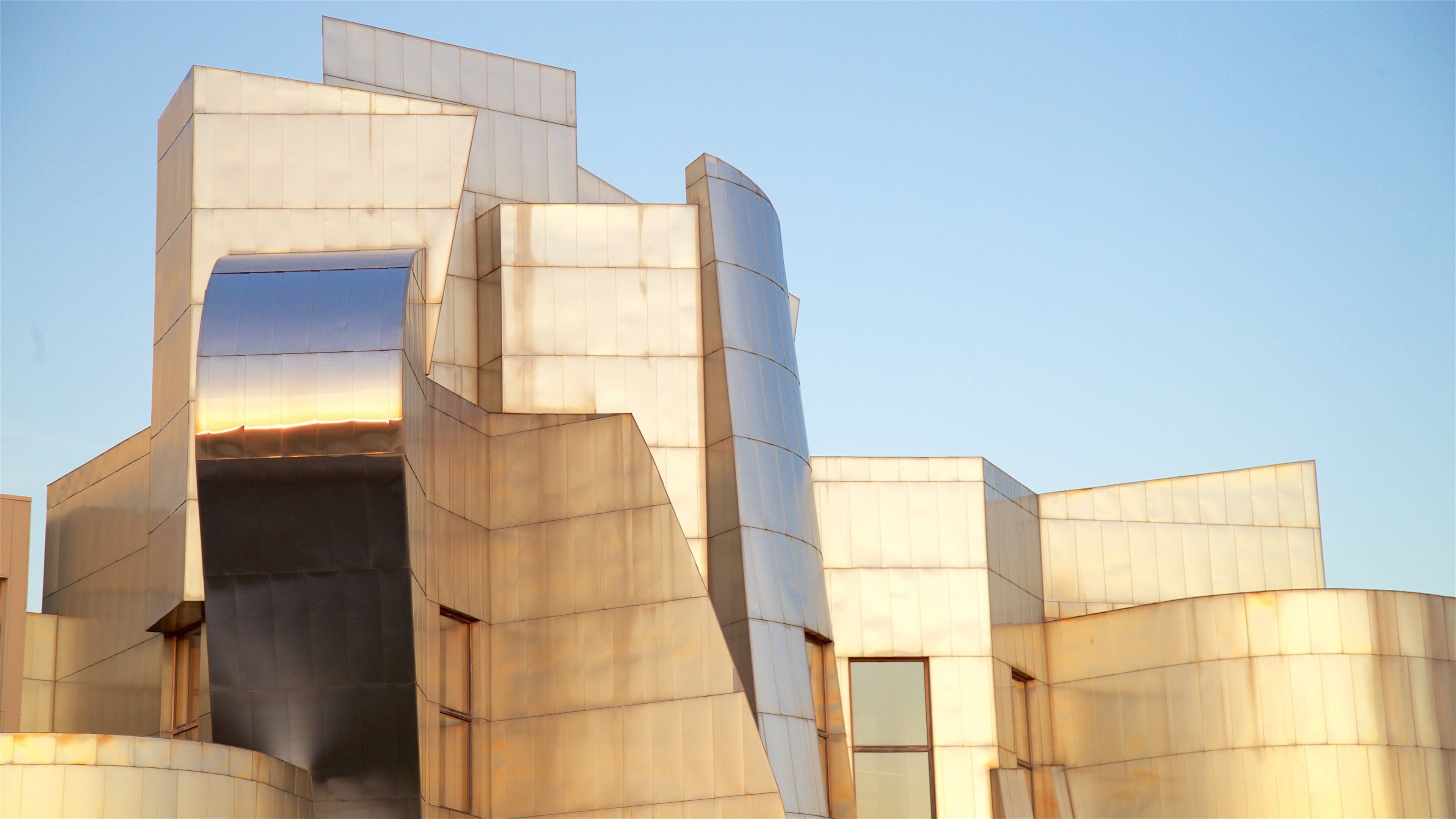 A modern architectural structure with geometric shapes and reflective surfaces.