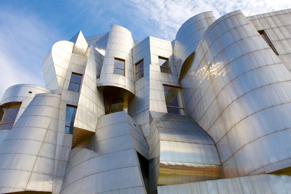 A modern architectural building with cylindrical and angular shapes.