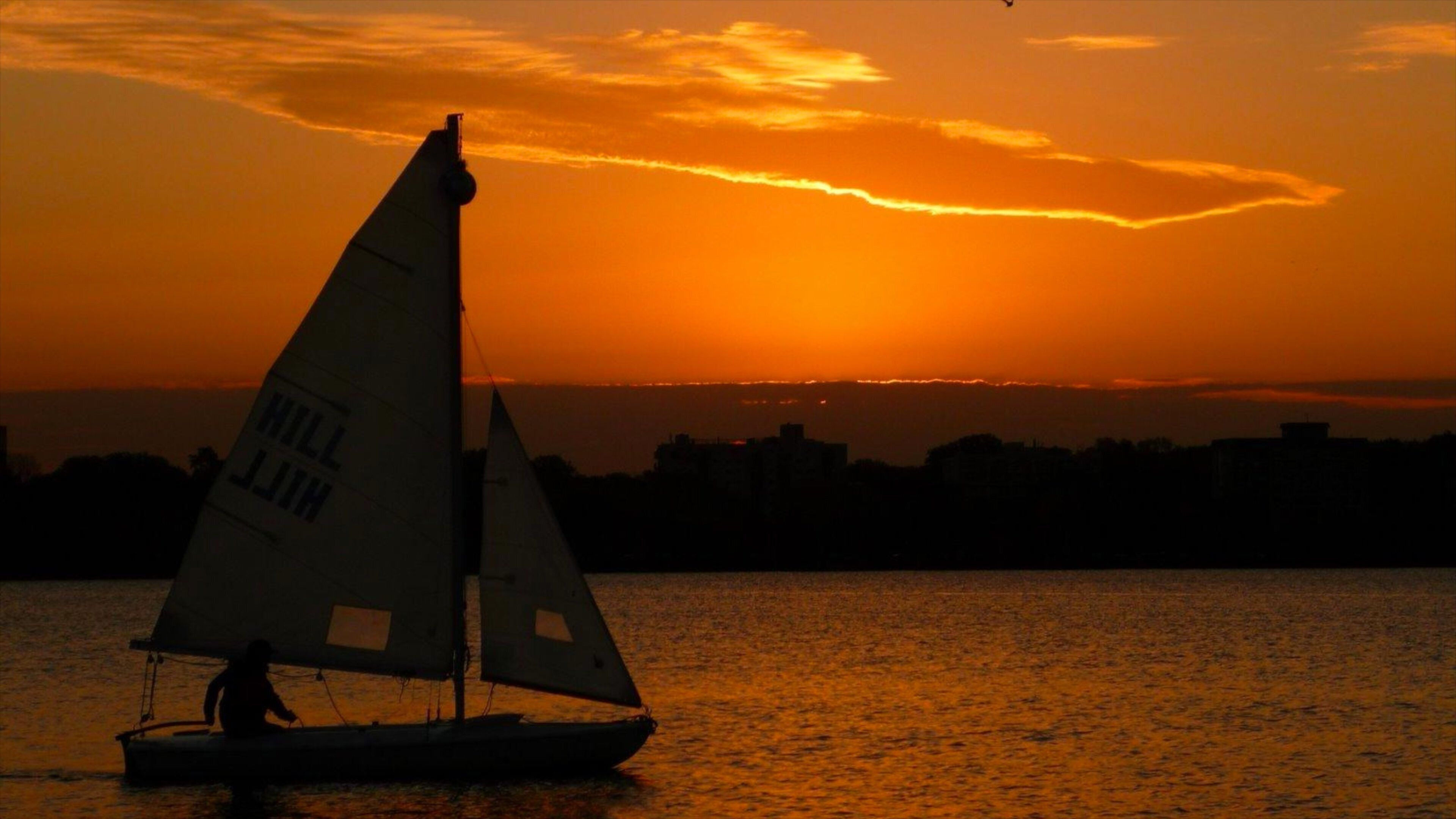 Bde Maka Ska which includes a sunset, night scenes and sailing