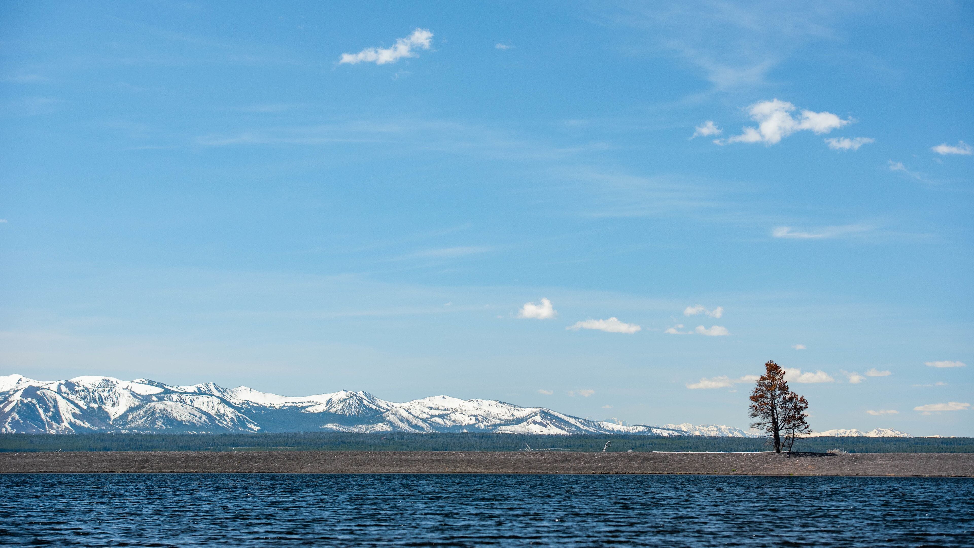 Yellowstone Lake which includes snow, a lake or waterhole and landscape views