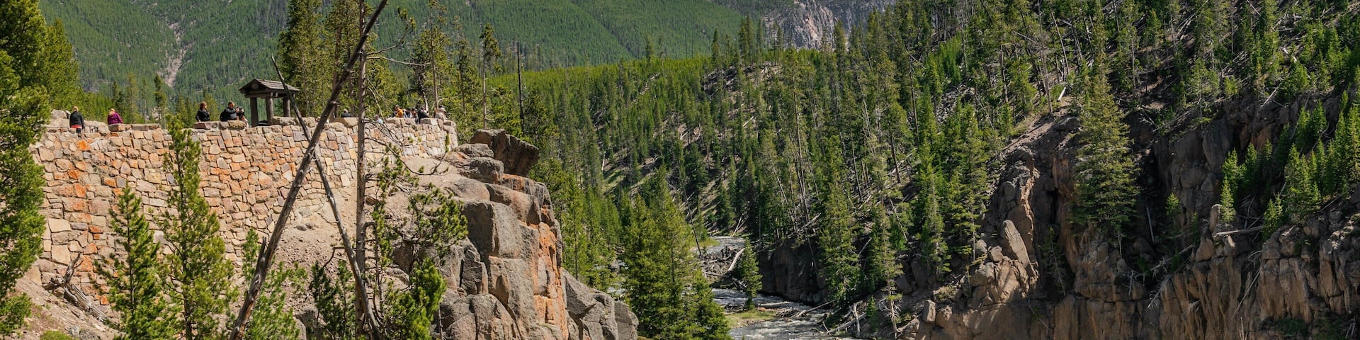 A waterfall cascading down a rocky cliff surrounded by dense forest.