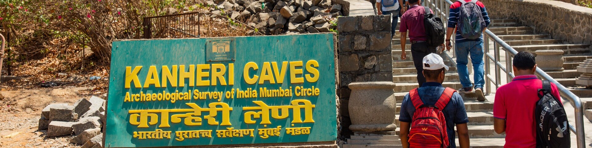Kanheri Caves which includes signage and hiking or walking as well as a small group of people